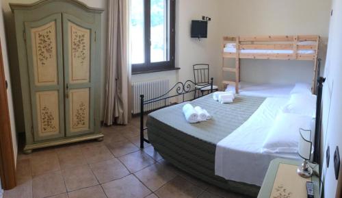 a bedroom with a bed and a bunk bed at Il Castagno in Montemonaco