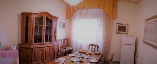 a dining room with a table and a china cabinet at B&B In Centro in San Benedetto del Tronto