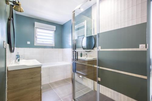 a bathroom with a shower and a sink at Le Temple, Studios & Appartement in Arras