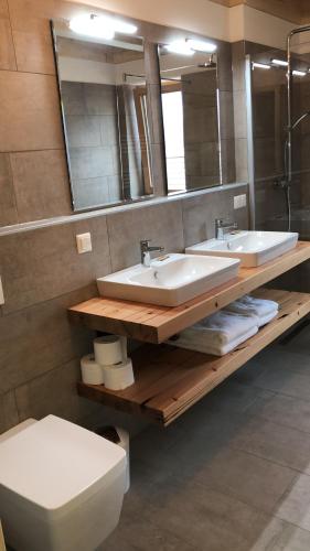 a bathroom with two sinks and a toilet and a mirror at Berghütte Murmele in Lachtal