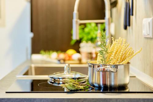 a kitchen counter with a pot of food on a stove at Strohhutmanufaktur in Dresden