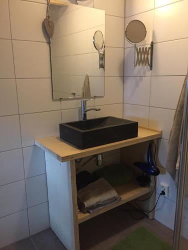 a bathroom with a black sink and a mirror at Tijdzat in Haaren