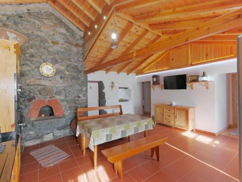 a large living room with a stone fireplace at Casas Dos Vimes in Fajã dos Vimes