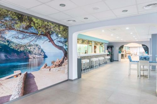a room with a wall mural of the ocean at NURA Boreal in Playa de Palma