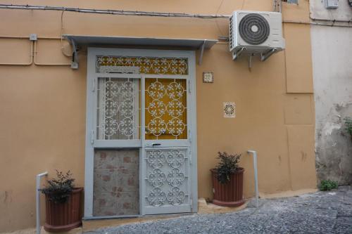 a door to a house with a window at Giallo Napoli in Naples