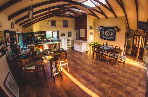 an overhead view of a kitchen and a living room with tables and chairs at Hostel Serena in Samaipata