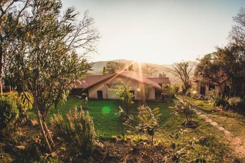 a house with a green yard in front of it at Hostel Serena in Samaipata