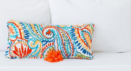 a colorful pillow with an orange flower on it at Bay Gardens Marina Haven in Gros Islet