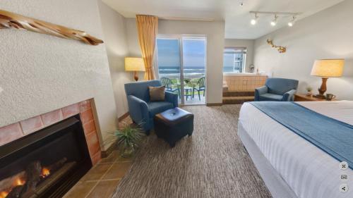 a hotel room with a bed and a fireplace at Overleaf Lodge and Spa in Yachats