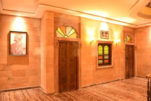 an empty room with brown walls and a door at Jodhpur Palace Guest House in Jodhpur
