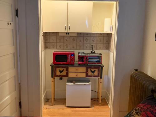 a room with a table with a microwave on it at Greenway Manor in Bisbee