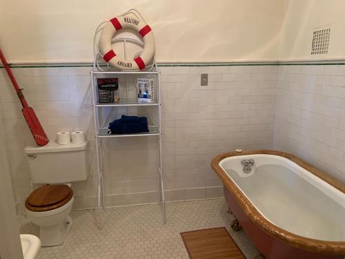 a bathroom with a bath tub and a life preserver at Greenway Manor in Bisbee