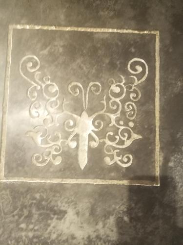 a cross etched into the side of a wall at Dar Faracha Fes in Fès