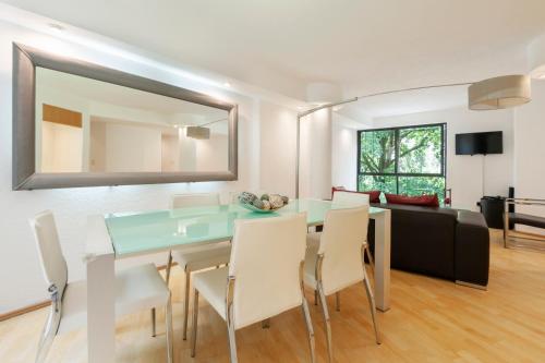 a living room with a table and chairs and a couch at Lovely apartment Ahuehuetes in Mexico City