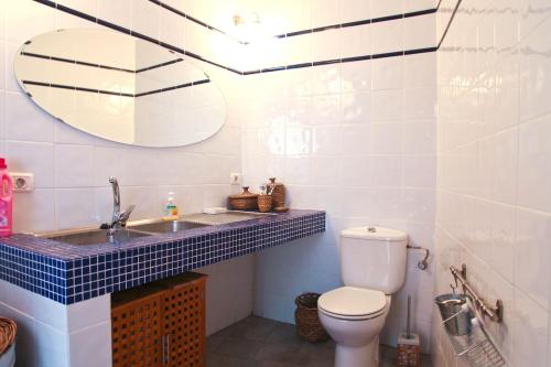 a bathroom with a toilet and a sink and a mirror at Villa with Ocean View in Agulo