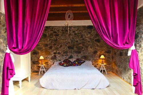 a bedroom with red curtains and a white bed at Villa with Ocean View in Agulo