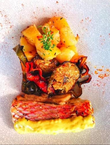 a pile of food on a white plate at Ocean Villas Apart Hotel in Grand Baie