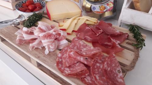 a tray of meats and cheese on a counter at La Casa di Nina in La Maddalena
