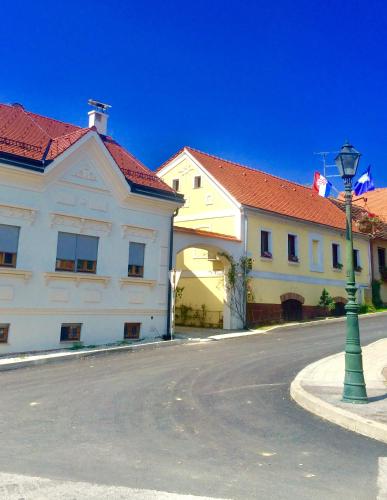 a street with two buildings and a light pole at Apartments Dajčić in Varaždinske Toplice