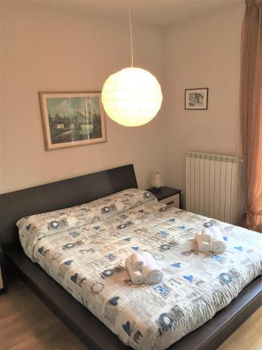 a bedroom with a bed with two stuffed animals on it at Casa Grazia in Magreglio
