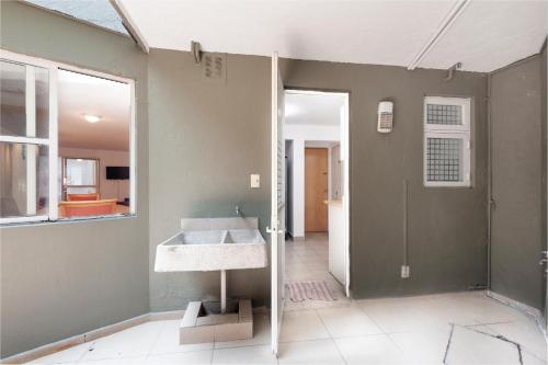 a bathroom with a sink and a mirror at Beautiful apartment Ahuehuetes in Mexico City