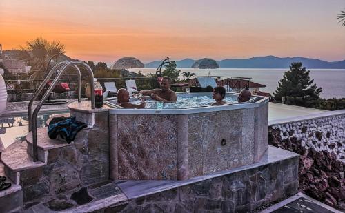 a group of people in a jacuzzi tub at a resort at PIOTROWSKI APARTMENTS in Theológos