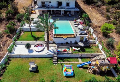 an aerial view of a house with a swimming pool at PIOTROWSKI APARTMENTS in Theologos