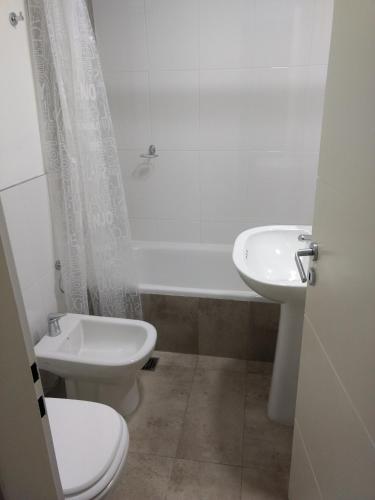 a bathroom with a toilet and a sink at Luxury Suite Salta in Salta