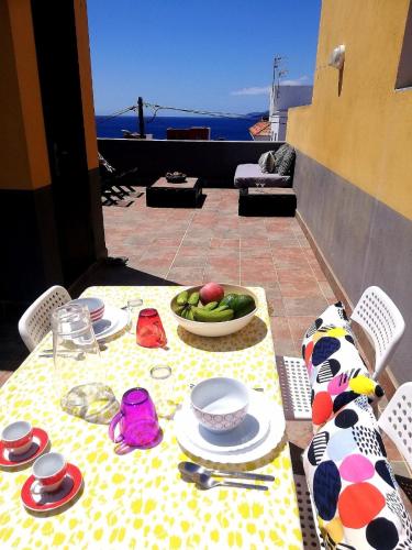 a table with a plate of food on top of a table at Apartamento La Caleta El Hierro Island terrace with incredible views in La Caleta
