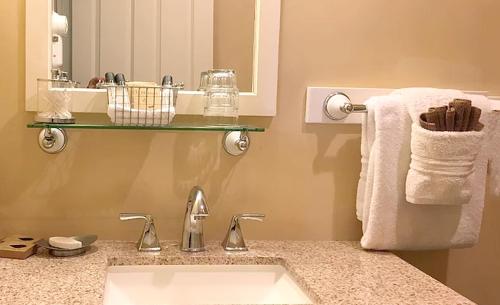 a bathroom with a sink and a mirror and towels at Kingfish at West Sound in Eastsound