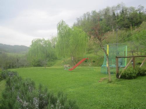 a yard with a playground with a slide at Fattoria Bertaccini in Cesena