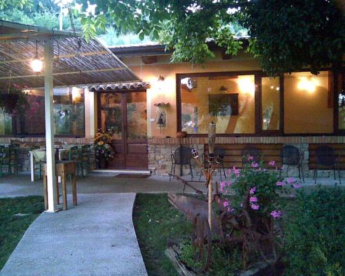 a house with a porch with a table and chairs at Fattoria Bertaccini in Cesena