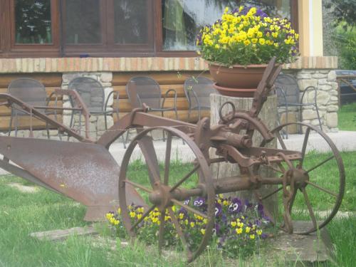 a statue of a tractor with a pot of flowers at Fattoria Bertaccini in Cesena