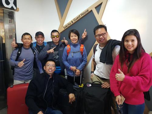 a group of people posing for a picture at an airport at Sokcho & Guesthouse in Sokcho