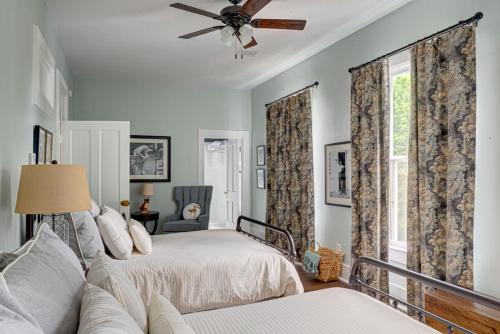 a bedroom with a bed and a ceiling fan at Historic Birch Lodge and Motel in Trout Lake