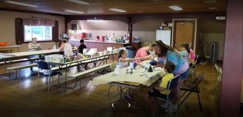 a group of people sitting at tables in a room at Round Top Two-Bedroom Cottage 8 in Gettysburg