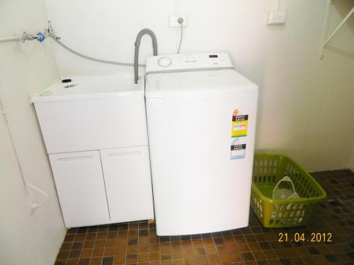 a small refrigerator and a water heater in a room at Champion Bay Apartments in Geraldton