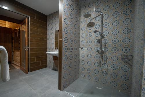 a bathroom with a shower and a sink at 39 St. George in Victoria