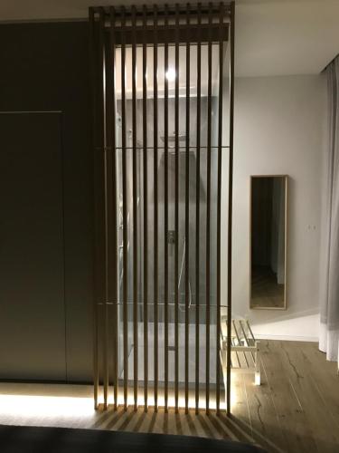a metal gate in a room with a wooden floor at Le Dimore Degli Archi Catania in Catania