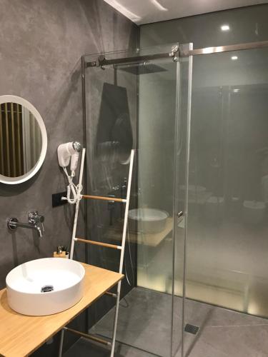 a bathroom with a glass shower and a sink at Le Dimore Degli Archi Catania in Catania