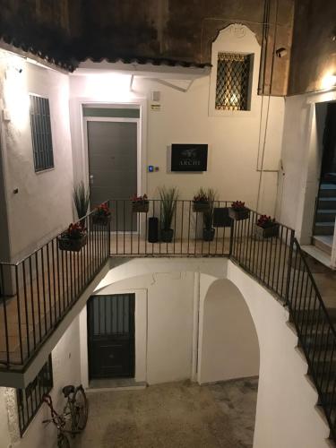 an external view of a building with a spiral staircase at Le Dimore Degli Archi Catania in Catania