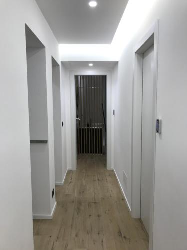 an empty hallway with white walls and wood floors at Le Dimore Degli Archi Catania in Catania