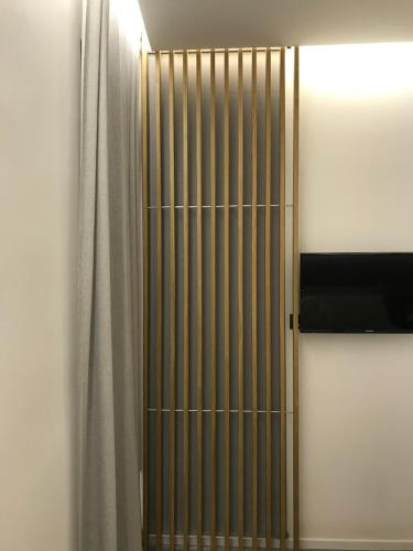 a metal gate in a room with a curtain at Le Dimore Degli Archi Catania in Catania