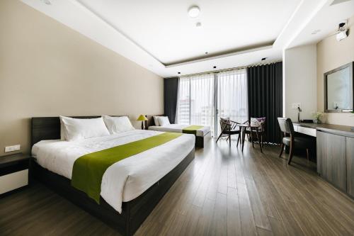 a hotel room with a large bed and a desk at Hana 2 Apartment & Hotel Bac Ninh in Bắc Ninh