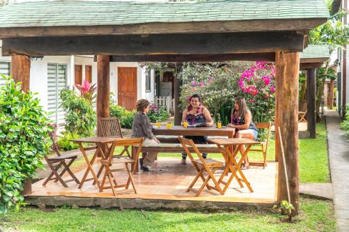 a group of people sitting at a table in a gazebo at Inaki Uhi Hotel in Hanga Roa