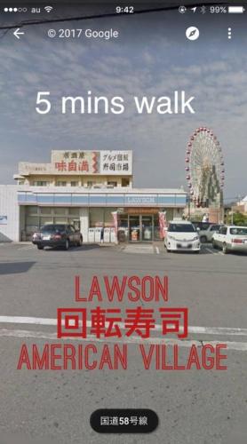 a sign for an american village in a parking lot at Wing Mihama in Chatan