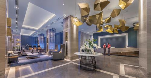 a lobby with gold triangles hanging from the ceiling at Summit Galleria Cebu in Cebu City