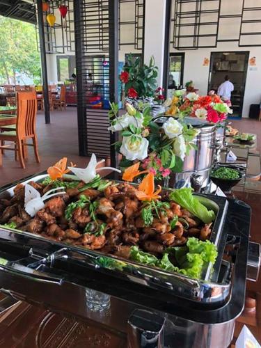 a platter of food on a buffet in a restaurant at Sang Như Ngọc Resort in Chau Doc