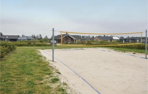 a volleyball court with a net on a beach at Bissebo in Hemmet