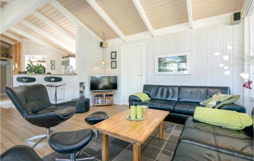 a living room with a couch and chairs and a table at Holiday Home Odde Naturpark Vi in Helberskov